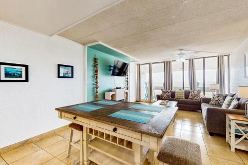 a living room with a table and a couch at Fairways #204 in Padre Island