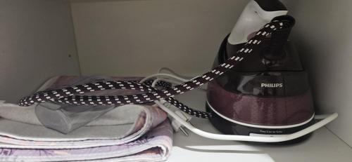 a bottle of wine and some towels in a refrigerator at Garibaldi Apartment Sanremo in Sanremo