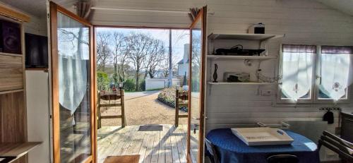 a caravan with a door open to a yard at Chalet in Plouër-sur-Rance