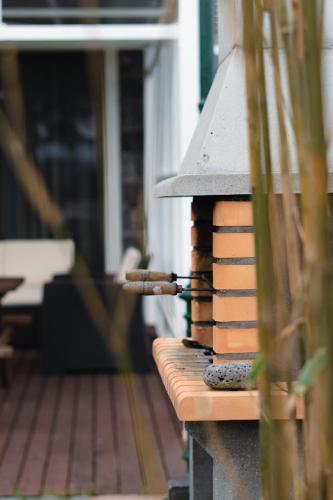 a bird house sitting on top of a porch at Batalha Golf Villas & Spa in Ponta Delgada