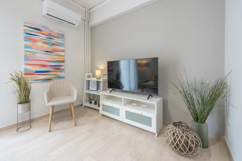 a living room with a television and a chair at Kallithea metro station in Athens