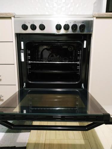 an oven with its door open in a kitchen at Kallithea metro station in Athens