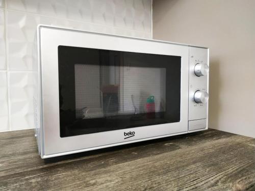 a microwave oven sitting on top of a wooden floor at Kallithea metro station in Athens
