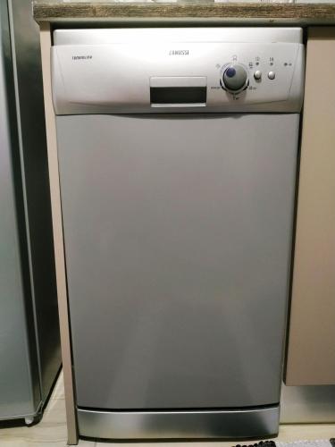 a dishwasher sitting under a counter in a kitchen at Kallithea metro station in Athens