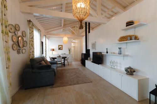 a living room with a couch and a tv at Batalha Golf Villas & Spa in Ponta Delgada