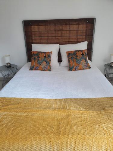 a bedroom with a bed with two pillows at stephane et virginie in Villemandeur