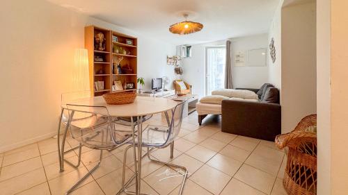 ein Wohnzimmer mit Tisch und Couch in der Unterkunft La Marinièro à 350m des plages - 4 couchages - Wifi in Toulon