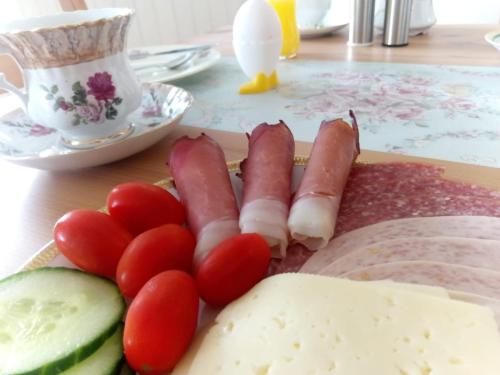 a plate of food with tomatoes and vegetables on a table at Villa Regina in Möhnesee