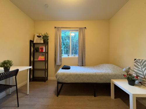 a bedroom with a bed and a window at Blue Private Room near BMO Stadium USC and K-Town in Los Angeles