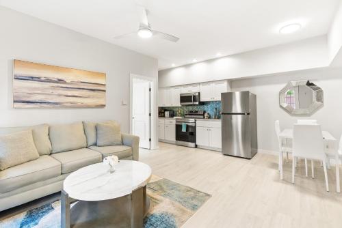 a living room with a couch and a table at Siesta Key Village, Heated Pool, Beach Access 4 min Walk, 1bdr in Siesta Key