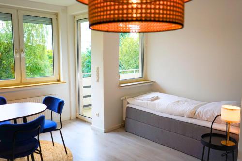 a bedroom with a bed and a table and chairs at unique - spacious for 5 - balcony - kitchen - WiFi in Bremen
