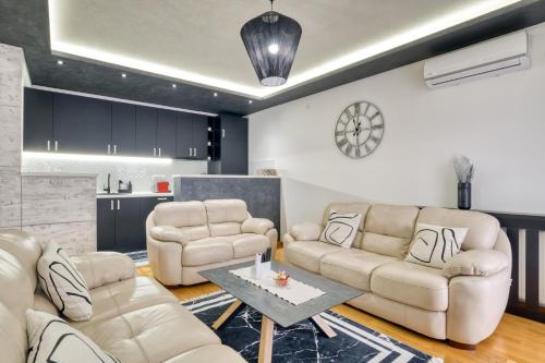 a living room with two couches and a table at Luxury Apartment Veselić in Valjevo