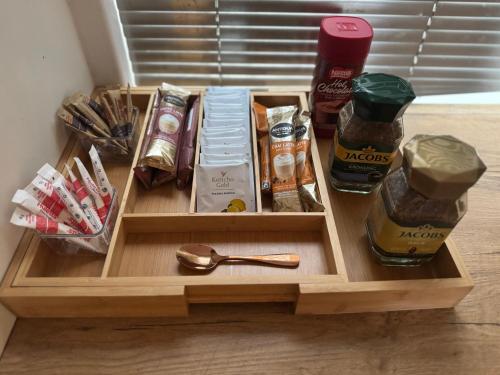 a wooden tray with some food and a spoon at The Falcon in Windhoek