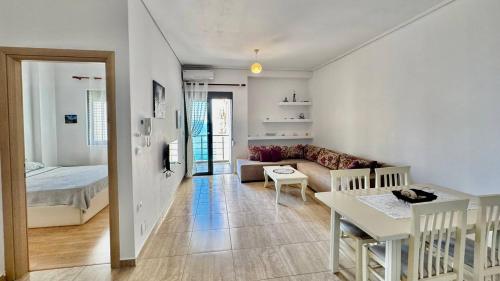 a living room with a couch and a table at 4 Seasons Sea View Apartment in Sarandë