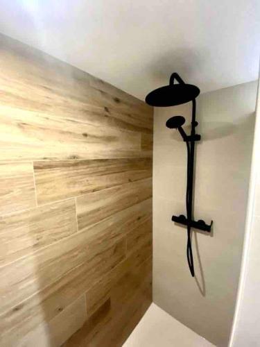 a room with wooden walls and a black cross on the wall at Apartament Cadaqués in Cadaqués