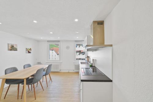 a kitchen and dining room with a table and chairs at book2stay - Apartments Herisau in Herisau