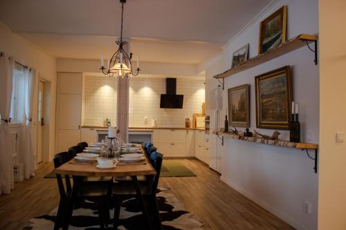 a dining room and kitchen with a table and chairs at Designer Country Apartment in Borlänge