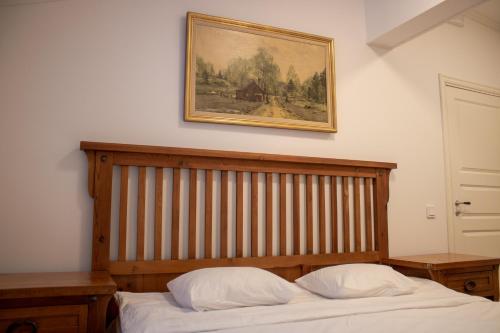 a bedroom with a bed and a picture on the wall at Designer Country Apartment in Borlänge