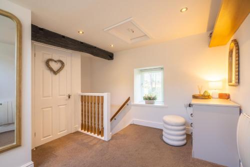 a hallway with a white door and a window at Bell Cottage - Cockermouth is five minutes walk to pubs, restaurants and shops in Cockermouth