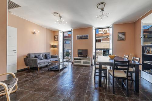 un salon avec une table et un canapé dans l'établissement Le Saint Charles-parking-climatisation-centre ville, à Menton