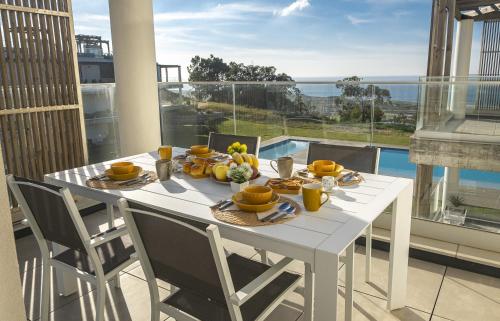 a white table with fruit on top of a balcony at Waves Nazare - by Smarthomes in Nazaré
