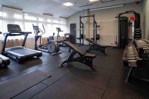 a gym with several exercise equipment in a room at Injoy Premium Hotel Solna in Solna