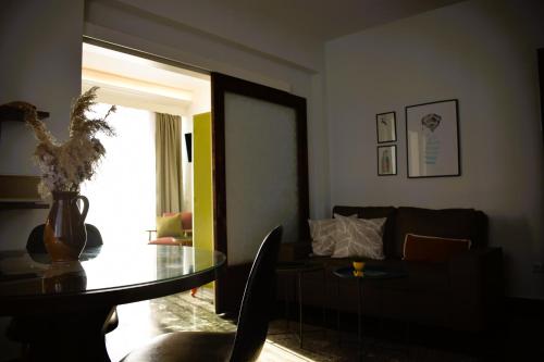 a living room with a table and a couch at Beach Side Apart II in Kavala