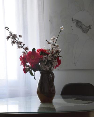 a vase filled with flowers sitting on a table at Beach Side Apart II in Kavala