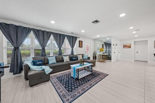 a living room with a couch and a table at Sweet Pink HouseCozy & QuietNear Beach, Parks in Riviera Beach