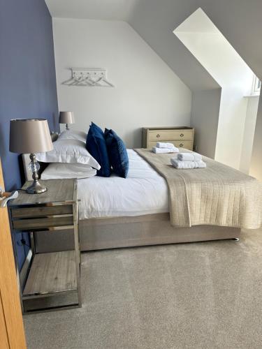 a bedroom with a bed and a table with a lamp at The Caradoc in Shrewsbury
