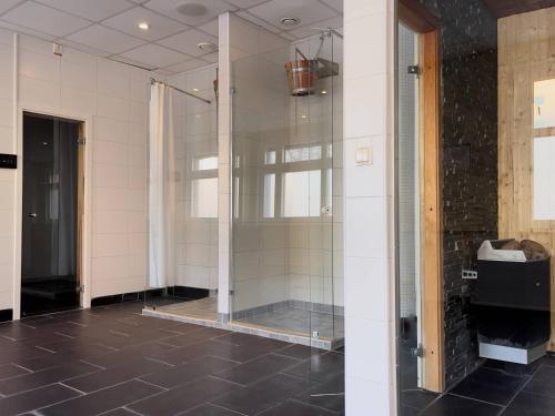 a bathroom with a shower with a glass door at Injoy Premium Hotel Solna in Solna