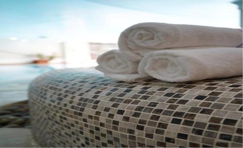 a pile of towels sitting on top of a couch at Hustyns Hotel in Wadebridge