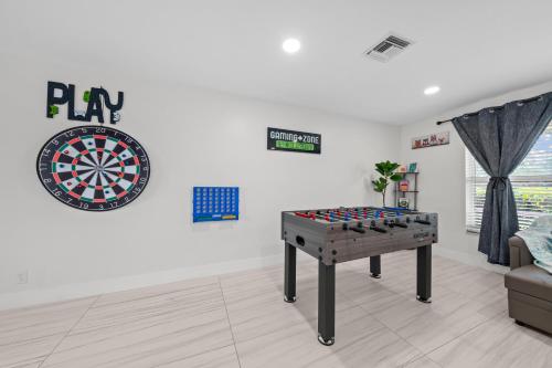 a room with a dart board on the wall at Sweet Pink HouseCozy & QuietNear Beach, Parks in Riviera Beach