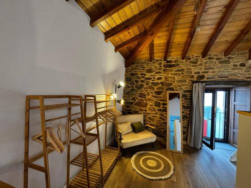 a living room with a ladder and a chair at Casa Erundina in Camariñas