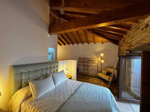 a bedroom with a large bed in a room at Casa Erundina in Camariñas