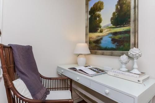 a desk with a chair and a picture on the wall at Stay at Black Rock Harbor in Bridgeport