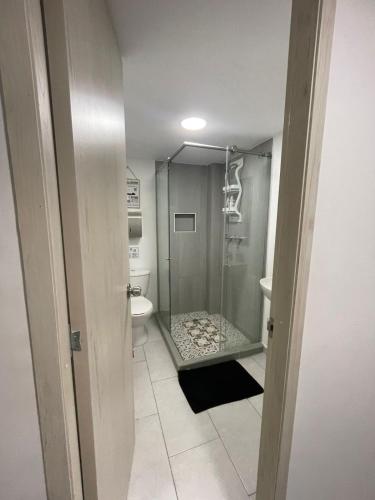 a bathroom with a shower and a toilet at Ingenio Park 83 - Apartahotel in Cali