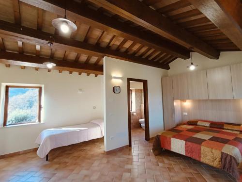 a bedroom with two beds and a window at Casa Paradiso - Assisi in Assisi