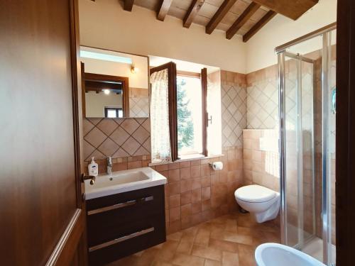 a bathroom with a sink and a toilet at Casa Paradiso - Assisi in Assisi