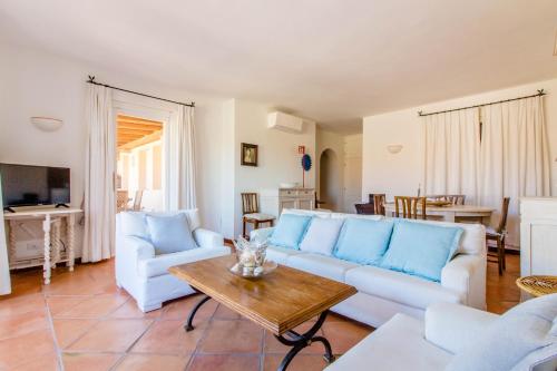 a living room with a couch and a table at Luxury apt in Porto Cervo square with parking in Porto Cervo