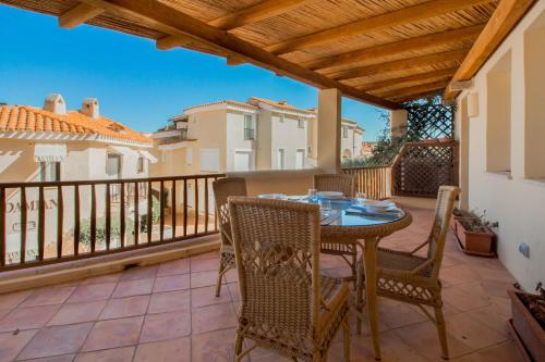 a patio with a table and chairs on a balcony at Luxury apt in Porto Cervo square with parking in Porto Cervo