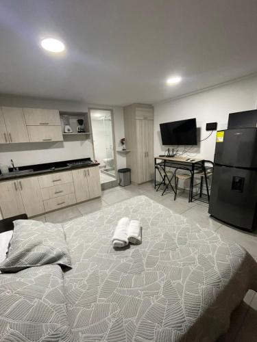 a large bed in a kitchen with two towels on it at Ingenio Park 83 - Apartahotel in Cali