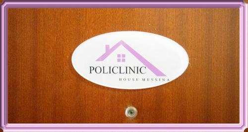 a sign on a wooden door with a house museum at Policlinic House Messina in Messina