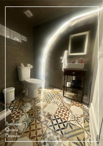 a bathroom with a toilet and a sink at Boutique Quinta Physalis in Fenais da Luz