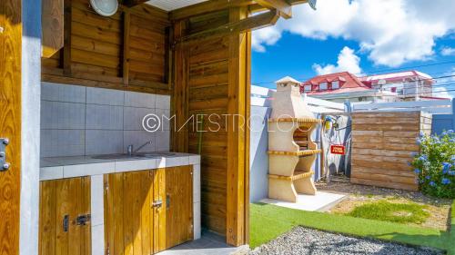 a outdoor kitchen with a sink and a grill at Offre à ne pas rater ! Gîtes Arc-en-ciel in Saint-François
