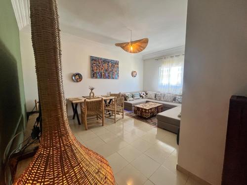a living room with a couch and a table at Apartment haut standing in Ghazoua