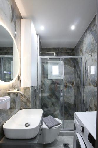a bathroom with a toilet and a sink and a shower at #Ioanna Apartments Unique in Thessaloniki