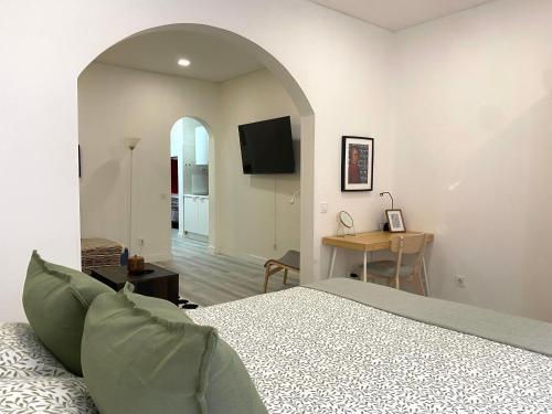 a bedroom with a bed and a table with a desk at Terrace House in Lisbon