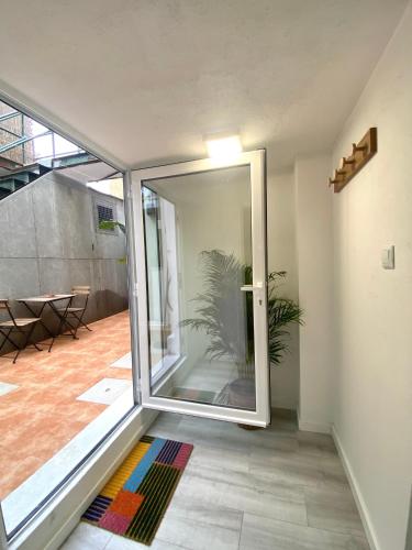 an open glass door in a room with a plant at Terrace House in Lisbon