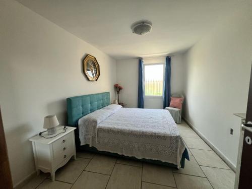 a bedroom with a bed and a table and a window at Villa dei Venti in Ostuni